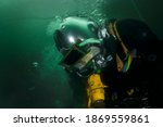 professional diver working underwater with pneumatic tools