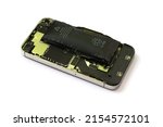 Swollen lithium ion polymer battery inside a mobile phone on isolated white background