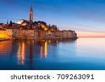 Sunset at medieval town of Rovinj, colorful with houses and church in Croatia