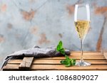 Food and drink, holidays party concept. Cold fresh alcohol beverage champagne sparkling white wine with bubbles in a flute glass on a wooden table. Copy space background