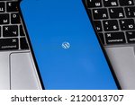 Small photo of WordPress logo mobile app on screen smartphone iPhone and Macbook closeup. WordPress - open source site content management system. Moscow, Russia - January 17, 2022