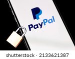 Small photo of PayPal logo mobile app on screen smartphone iPhone with metal lock closeup. Paypal is an internet based digital money transfer service. Moscow, Russia - February 26, 2022