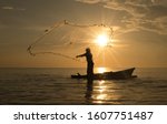 Silhouette Of Fisherman In...