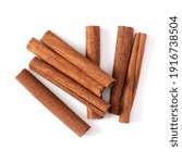 Small photo of Cinnamon sticks isolated over white background closeup. Canella spice. Aromatic condiment background. Flat lay, top view.