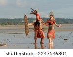 Small photo of Labuan,Malaysia-Jan 30,2022:The Iban ethnic of Sarawak Borneo with full traditional tribe costume dancing at the beach of Labuan,Malaysia. The Iban community lived in longhouses located in Sarawak.