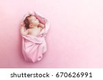 Newborn baby girl sleep on pink blanket
