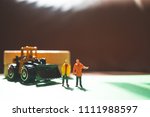Miniature people, couple engineers standing at construction site using as logistic and industry concept