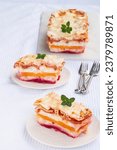 Small photo of Colorful Layers Lasagna. A 3 layered lasagna made with tomatoes, sweet potatoes beetroot and cheese between the layers