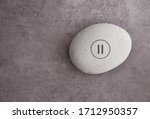 Yoga zen stone with a pause symbol