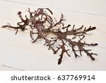 Small photo of Mizzen red leaves on a white wooden background. Japanese vegetable salad.