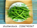 garden fresh indian vegetable green cluster beans or guar beans in dish also known in india as guwar,guvar bean,guar bean  