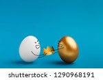 Small photo of Fight for crown. Leadership tussle among two opponents, competition between white and golden eggs on blue background, copy space