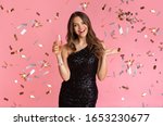 Posh Party. Glamour Woman In Sequin Evening Dress Standing With Glass Of Champagne Under Falling Confetti, Pink Background