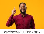 Small photo of Great Idea Concept. Young Funny African American Man Pointing Finger Up. Excited Black Guy Got Solution To His Problem, Having Aha Moment, Isolated On Yellow Studio Background. Wow, Eureka