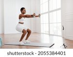 Positive black lady exercising...