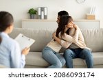 Small photo of Loving arab couple hugging in counselor's office after successful marital therapy, being grateful to professional psychologist. Happy man and woman embracing, celebrating saved marriage