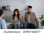 Small photo of Angry arab couple on meeting with marital counselor, having conflict and talking emotionally at phychologist's office. Young spouses having relationship problems, consulting therapist at clinic