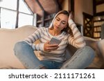 Small photo of Bad News Concept. Upset Confused Woman Holding Smartphone, Looking At Mobile Phone Screen With Worried Expression, Touching Head, Sad Adult Female Reading Unplesant Message Sitting On Couch