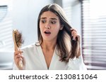 Small photo of Shocked Female Brushing Hair In Bathroom And Worried About Hairloss, Terrified Upset Young Woman Standing In Bathroom And Holding Comb Full Of Fallen Hair, Emotionally Reacting To Beauty Problems