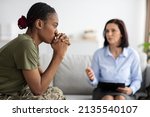 Small photo of Upset Pensive Black Military Lady Having Therapy Session With Psychologist In Office, African American Soldier Woman Suffering Mental Illness Or Posttraumatic Stress Disorder, Selective Focus