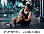Small photo of Sport Injury. Upset Arab Male Athlete Suffering From Knee Trauma While Training At Gym, Middle Eastern Man Sitting On Floor And Massaging Aching Area, Sporty Guy Frowning With Pain, Copy Space