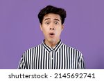 Small photo of Wow, Omg. Portrait Of Surprised Asian Guy Opened Mouth In Amazement, Shocked Young Man Looking Stunned And Impressed, Emotionally Reacting To News Isolated Over Purple Violet Studio Background