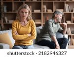 Small photo of Marital Crisis. Upset Middle Aged Womam Sitting Offended After Argue With Husband At Home, Depressed Pensive Lady Tired Of Domestic Conflicts With Spouse, Suffering Crisis In Relationship