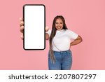 Black Plus Size Lady Showing Large Mobile Phone Empty Screen To Camera Smiling Posing On Pink Studio Background. Check This Application. Gadgets Offer Concept. Mockup