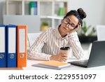 Tired female employee sleeping at work, exhausted woman resting at desk near laptop and folders, napping in the end of hard working day, free space