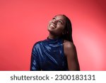 Dreamy Young Black Woman In Sequin Party Dress Looking Up At Copy Space, Happy Smiling Beautiful African American Female With Artistic Makeup And Nose Piercing Posing Over Red Background