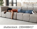 Small photo of Exhaustion Concept. Tired Young Black Woman Sleeping On Couch At Home, Exhausted African American Woman With Smartphone In Hand Buried Face In Sofa, Napping In Living Room, Suffering Luck Of Energy