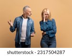 Small photo of Psychological violence. Mature family couple experience marriage crisis, relationship problems. Angry irritated jealous old age husband abuser scold stressed upset senior wife, beige background
