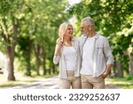 Small photo of Romantic Senior Couple Walking Outdoors In Summer Park And Embracing, Loving Happy Mature Spouses Hugging And Smiling To Each Other, Cheerful Husband And Wife Enjoying Outside Walk, Copy Space