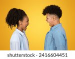 Small photo of Sad angry African American young wearing casual clothing laugh heartily face-to-face against a vibrant yellow background, capturing a moment bad connection, close up, profile