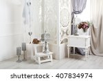 Shabby chic interior. Wedding decor, room decorated for rustic wedding, with bedside table, folding screen or room divider with white tracery and rose bouquets. High key