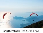 Paraglider flying on Oludeniz beach in Fethiye, Mugla. Travel destination. Summer and holiday concept.