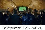 Small photo of WIDE Model released, fans watching a game on a large TV in a sport pub, celebrating a goal, green screen chroma key