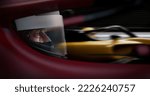 Small photo of ECU Portrait of sports car driver in protective helmet racing on a speedway. Fast speed, motorsport