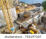Small photo of Scena, Italy - July 21, 2016: Elevated view on a construction site with crane in Sankt Georgen / Shena above Merano.