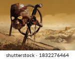 Small photo of Photo of a post apocalyptic raider warrior metal armor mask hanging on cross sign on desert wasteland background.