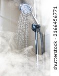 Small photo of contrast shower with flowing water and steam