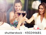Picture presenting happy group of friends with red wine