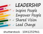 LEADERSHIP written on a white background and colour pencils. Business concept.Top view.
