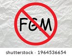 Small photo of Stop female genital mutilation sign on white crumpled paper.