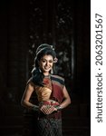 Small photo of Young female Actress wearing beautiful ancient costumes, in ancient monuments, dramatic style. Perform on legend love popular story, Thai Isan folktale called "Phadaeng and Nang-ai" in acient site