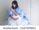 Small photo of A despondent Asian woman patient. Following the doctor's declaration that the cancer was nearing the end of its course.