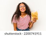 Small photo of Young hispanic woman holding crips isolated on white background laughing and having fun.
