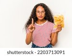 Small photo of Young hispanic woman holding crips isolated on white background showing number one with finger.