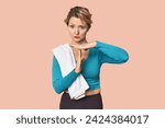 Small photo of Caucasian woman in sportswear with towel showing a timeout gesture.
