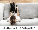 Young Woman Relaxing On Sofa At ...